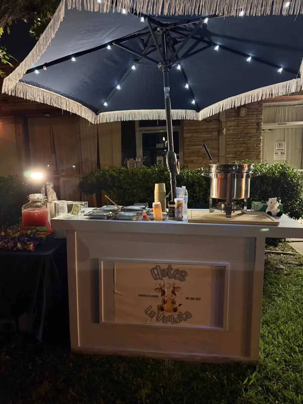The cart at night with a lit umbrella