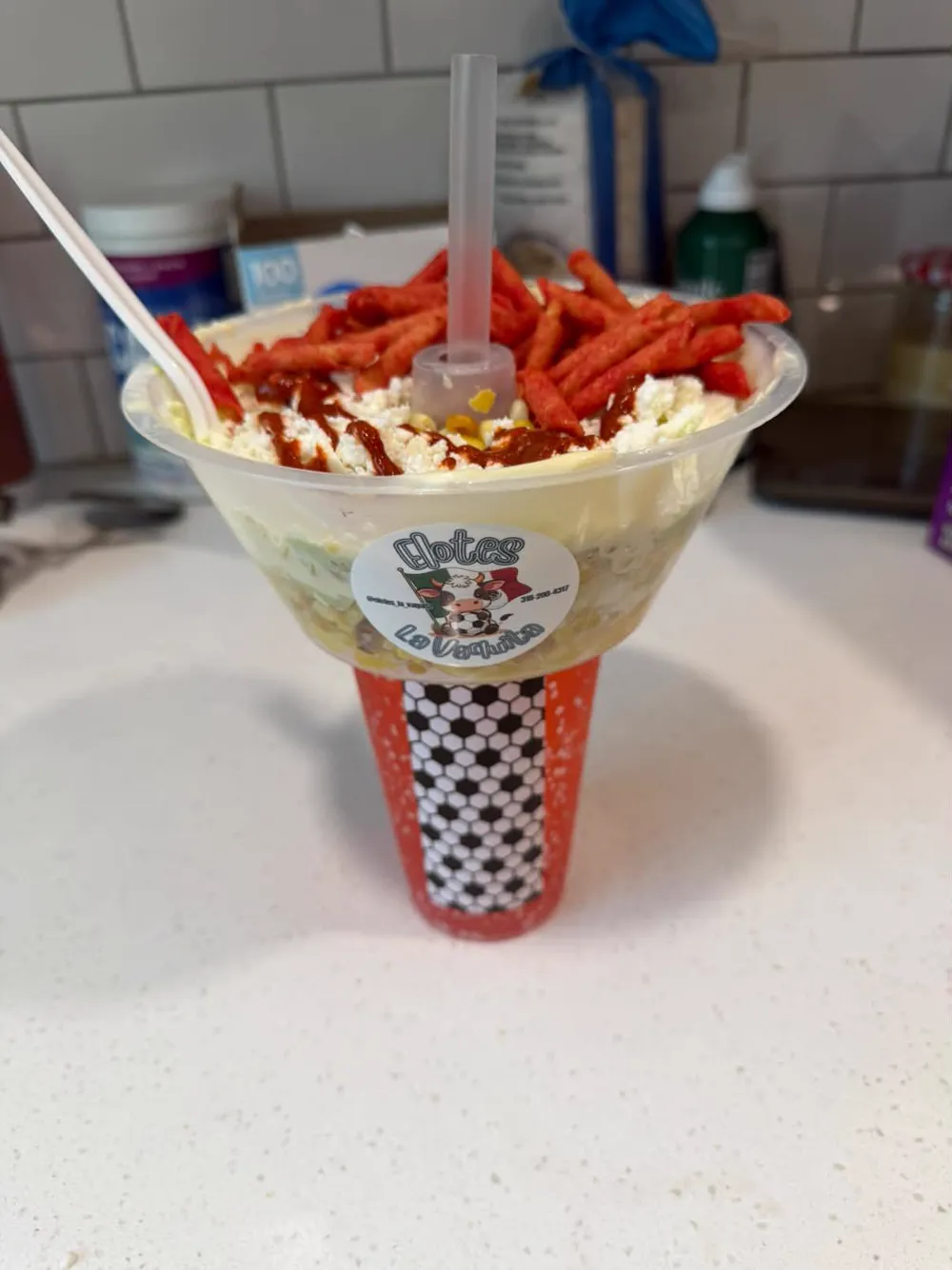 Elote cup topped with Takis