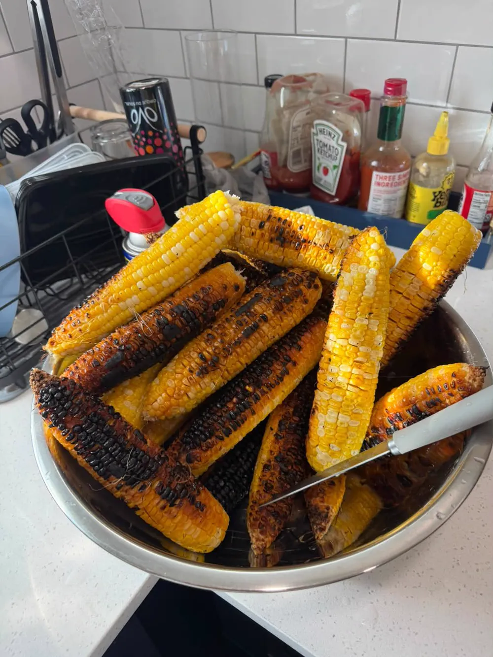 A bowl of charred corn on the cob
